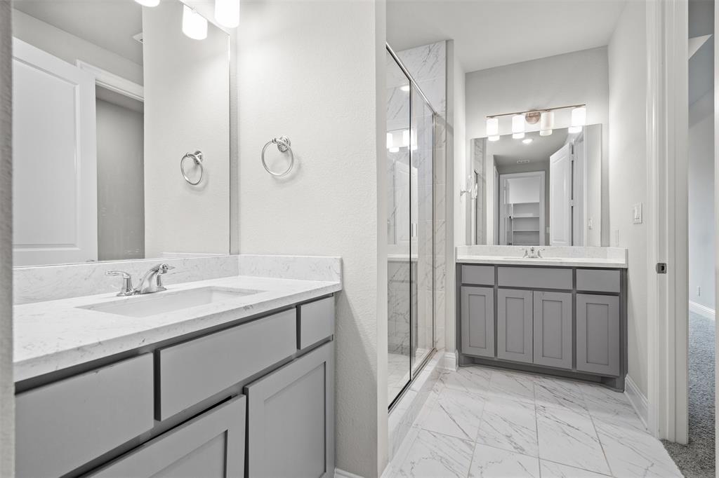 4505 Fall Mdw Drive Prosper, TX 75078 - Photo 16 of 34 a bathroom with a sink vanity and mirror