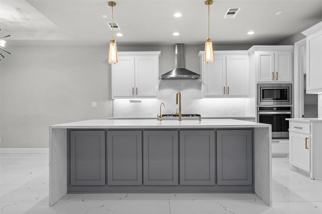4505 Fall Mdw Drive Prosper, TX 75078 - Photo 8 of 34 a kitchen with counter top space cabinets and stainless steel appliances