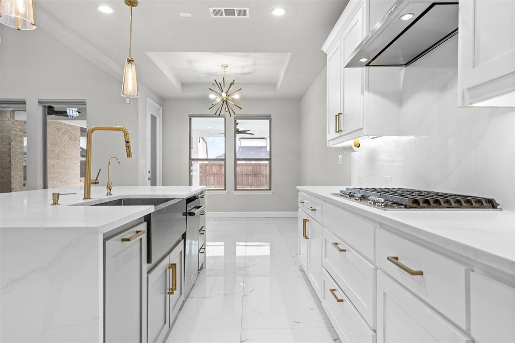 4505 Fall Mdw Drive Prosper, TX 75078 - Photo 10 of 34 a kitchen with stainless steel appliances a sink stove and cabinets