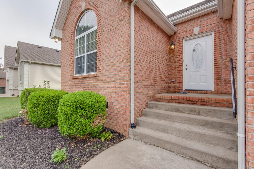 144 Fieldstone Lane Springfield, TN 37172 - Photo 3 of 24 a view of a brick house with plants and large windows