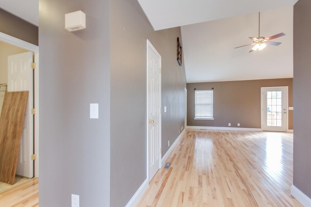 144 Fieldstone Lane Springfield, TN 37172 - Photo 4 of 24 a view of an empty room with wooden floor and a window