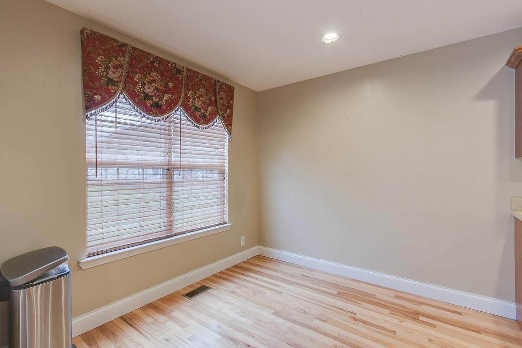 144 Fieldstone Lane Springfield, TN 37172 - Photo 8 of 24 a view of an empty room with wooden floor and a window