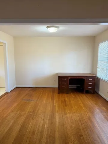 a view of a room with wooden floor and chair