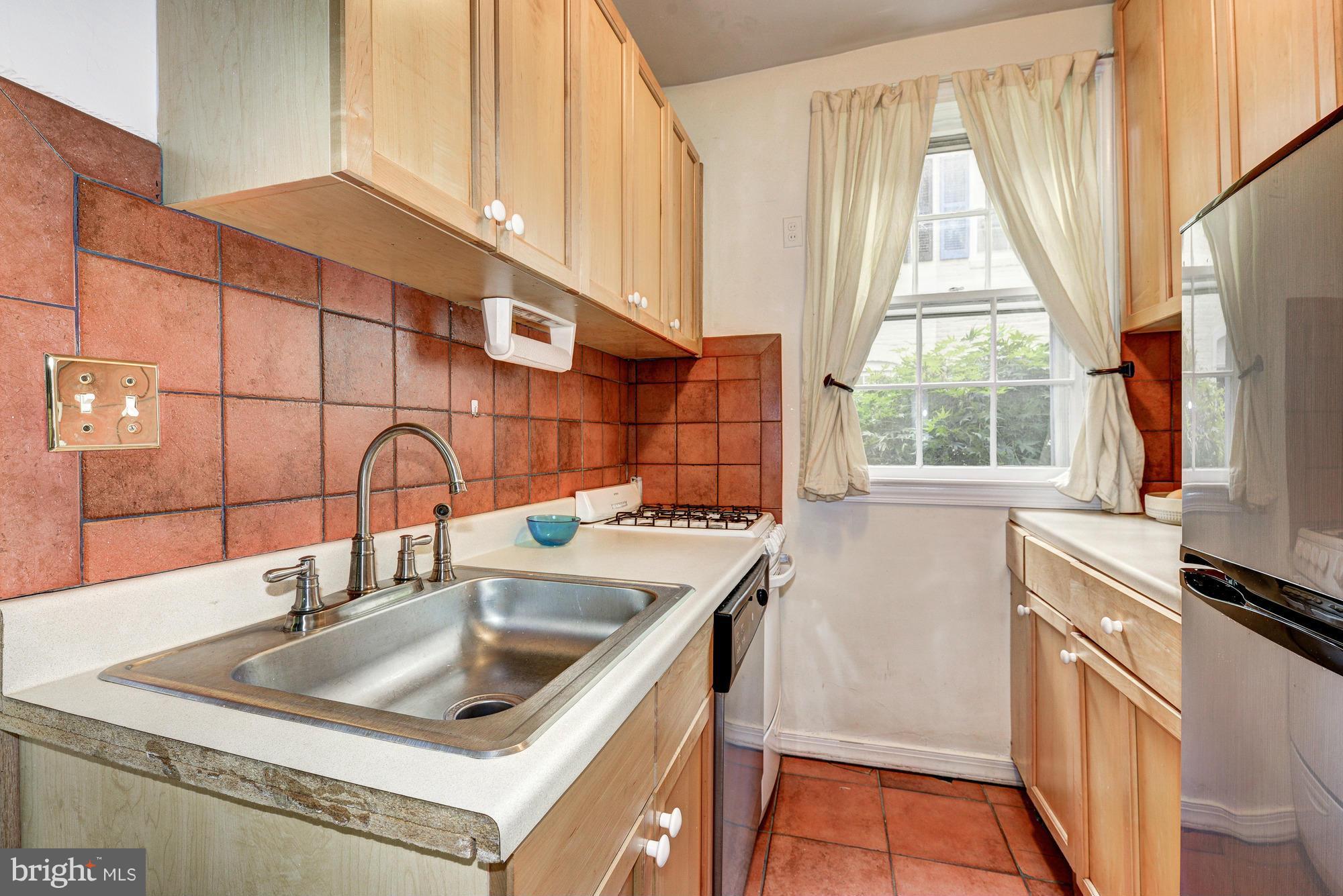 7 Pomander Walk Northwest Washington, DC 20007 - Photo 6 of 23 a kitchen that has a sink and a stove