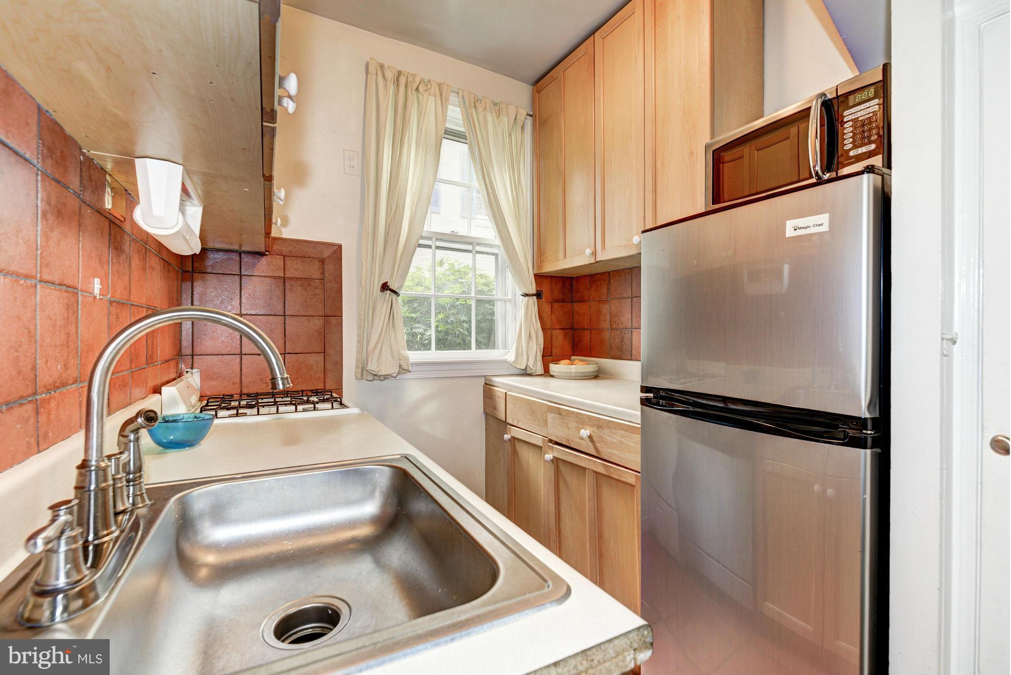 7 Pomander Walk Northwest Washington, DC 20007 - Photo 7 of 23 a kitchen with a refrigerator and a sink