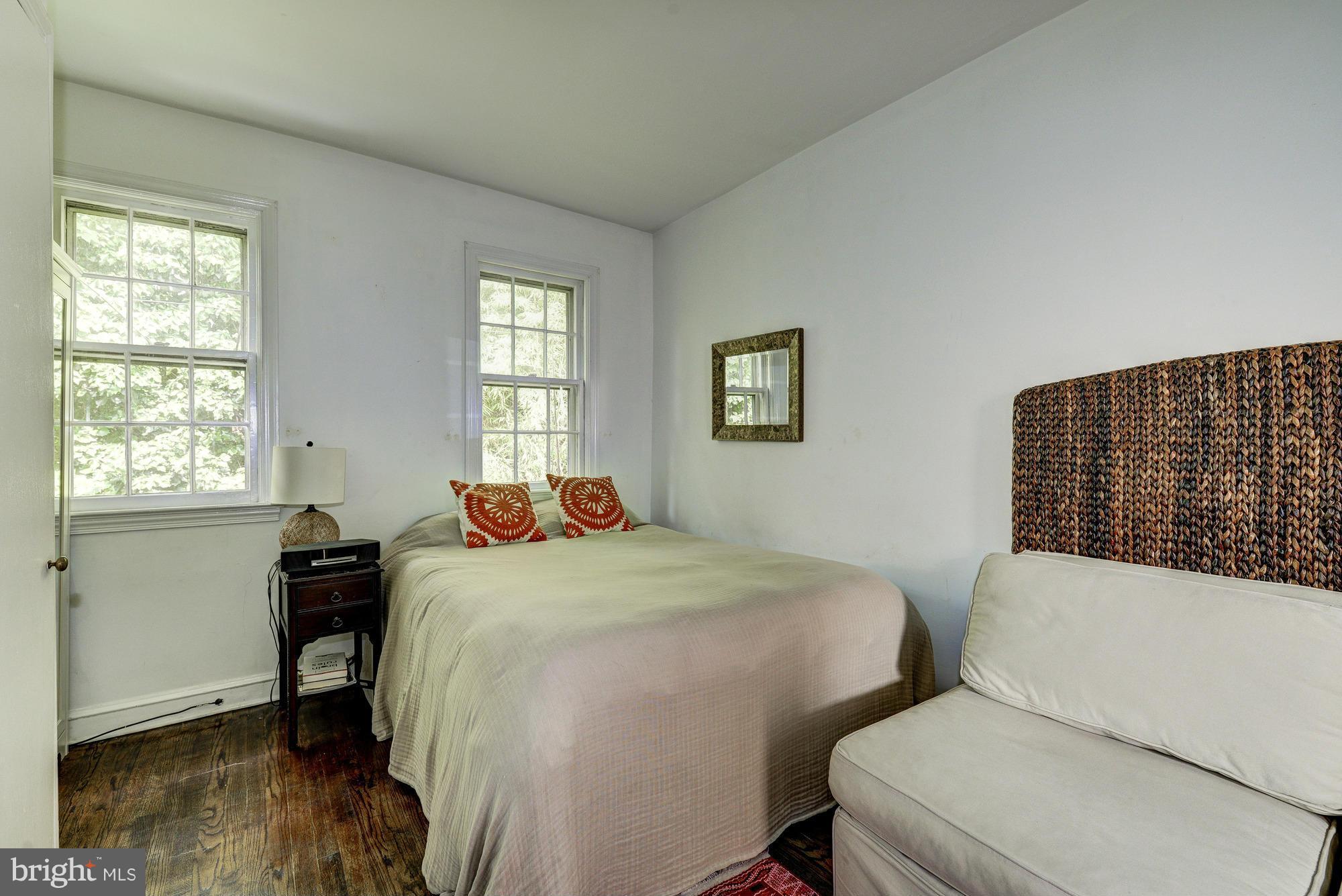7 Pomander Walk Northwest Washington, DC 20007 - Photo 8 of 23 a bedroom with a bed and wooden floor