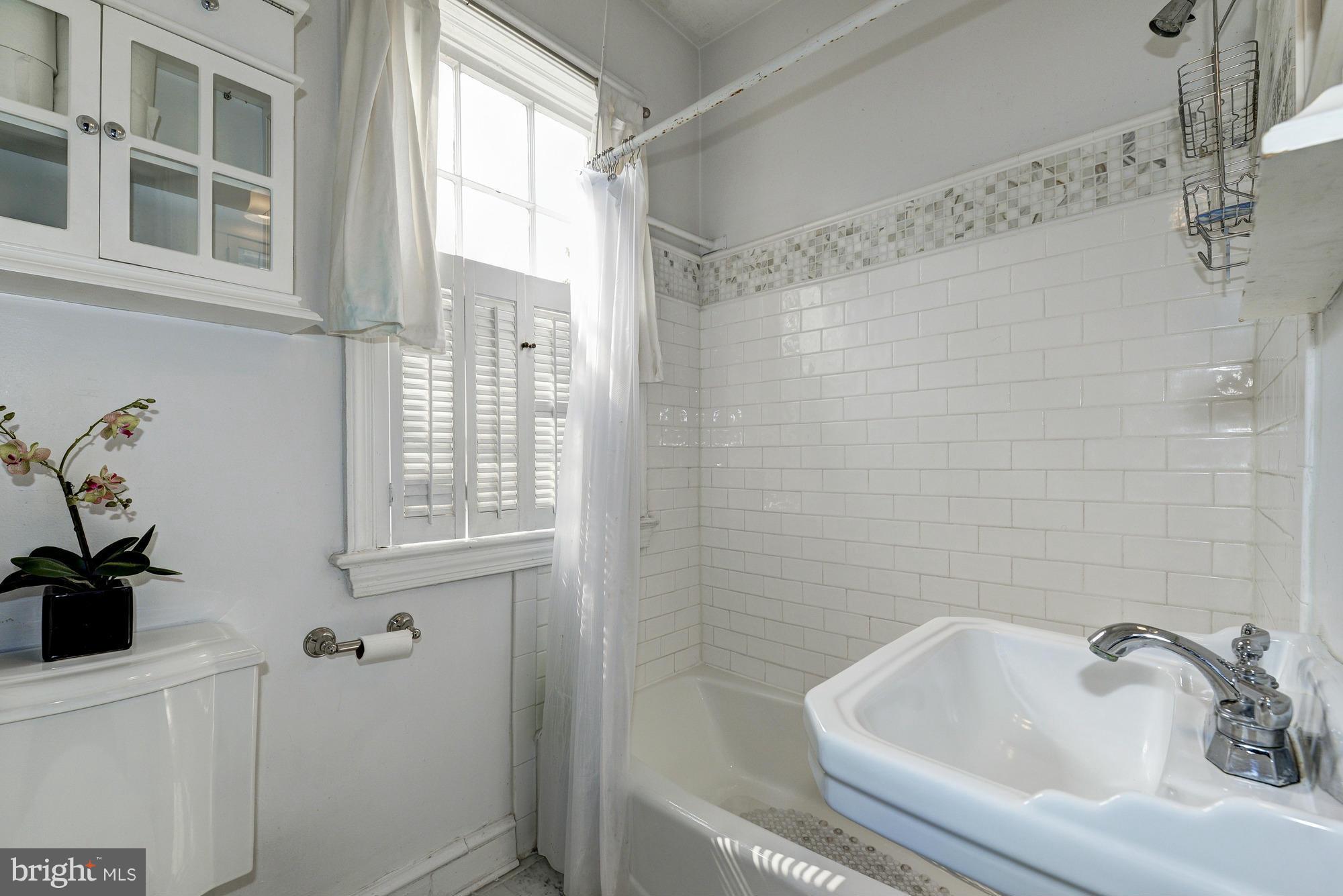 7 Pomander Walk Northwest Washington, DC 20007 - Photo 10 of 23 a bathroom with a sink a window and shower