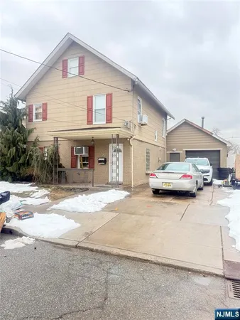 a car parked in front of white house