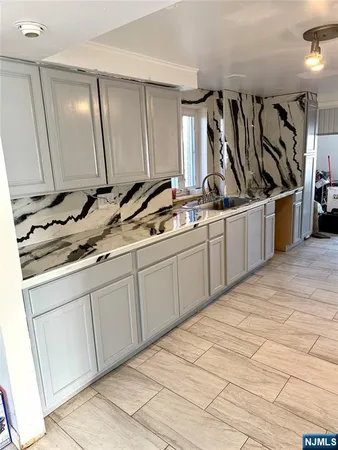 a kitchen with stainless steel appliances a sink and a refrigerator