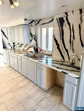 a kitchen with stainless steel appliances granite countertop a sink and cabinets