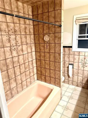 a bathroom with a bathtub and shower
