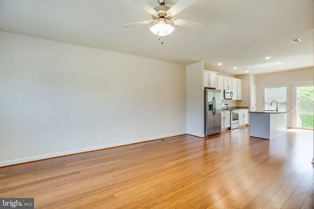 a kitchen with stainless steel appliances granite countertop a refrigerator a sink and a stove