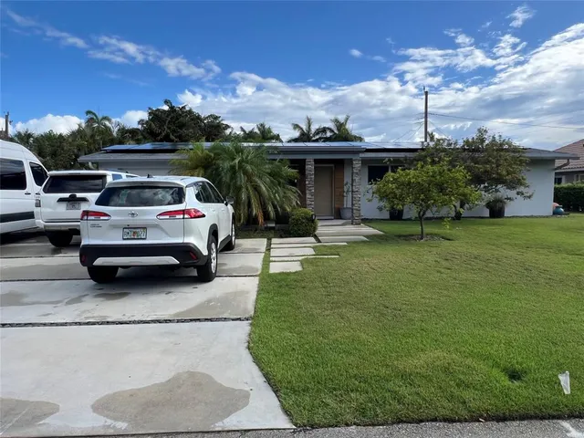a view of a car park in front of the house