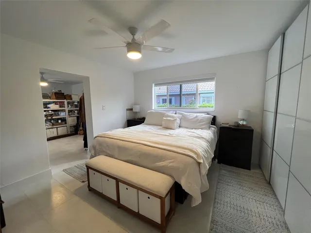 a spacious bedroom with a bed and a window