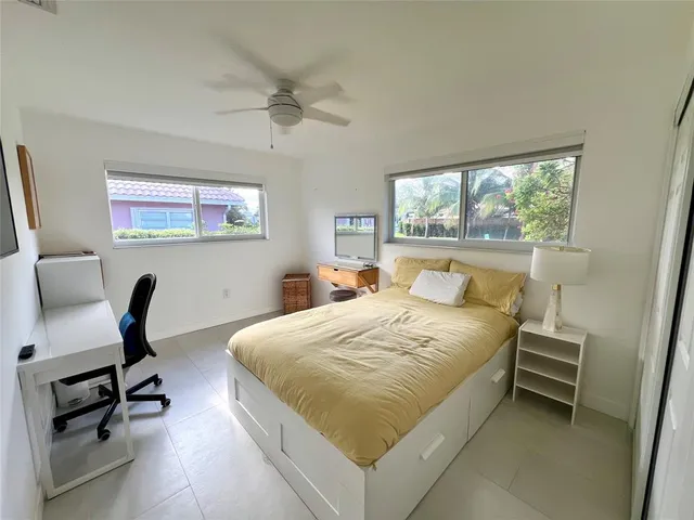 a bedroom with a bed chair and a window