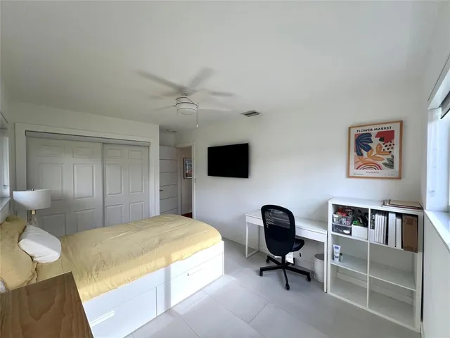 a bedroom with a bed and a chair