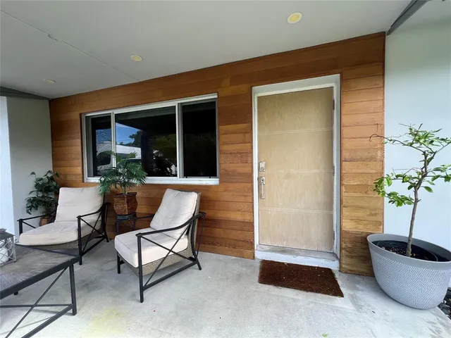 a view of a house with backyard sitting area and tub