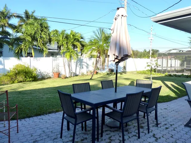 a view of an chairs and table in the patio