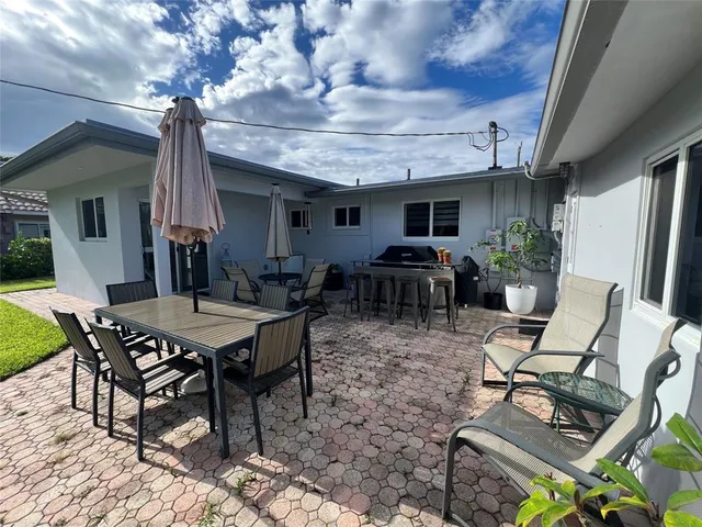 a view of a dinning table and chairs in the patio