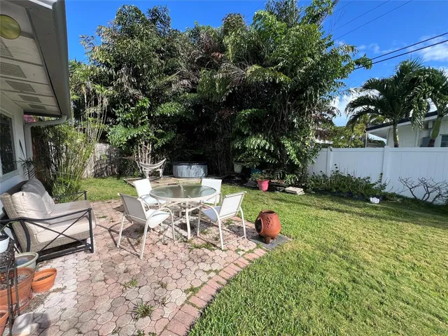 a view of a chair and table on the garden