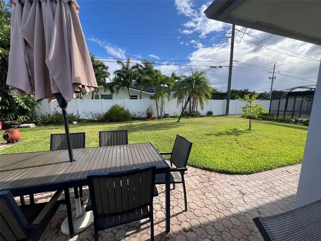 a view of a patio with a table chairs and a table