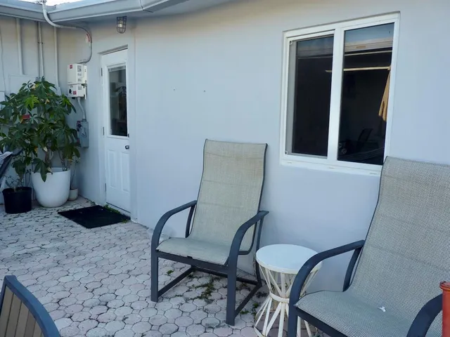 a view of a door and chair in the patio