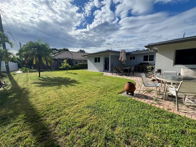 a view of a house with backyard porch and sitting area