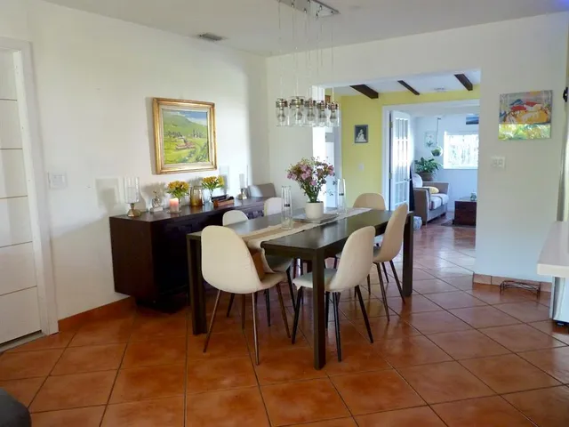 a dining room with furniture and window