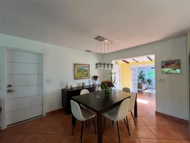 a dining room with furniture and window