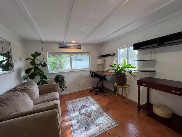 a living room with furniture and a potted plant