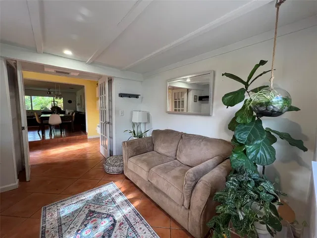 a living room with furniture and a potted plant