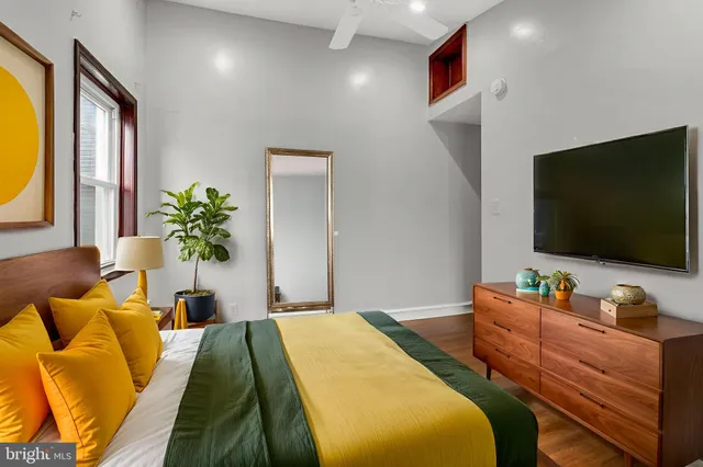 a bedroom with a bed and a flat screen tv