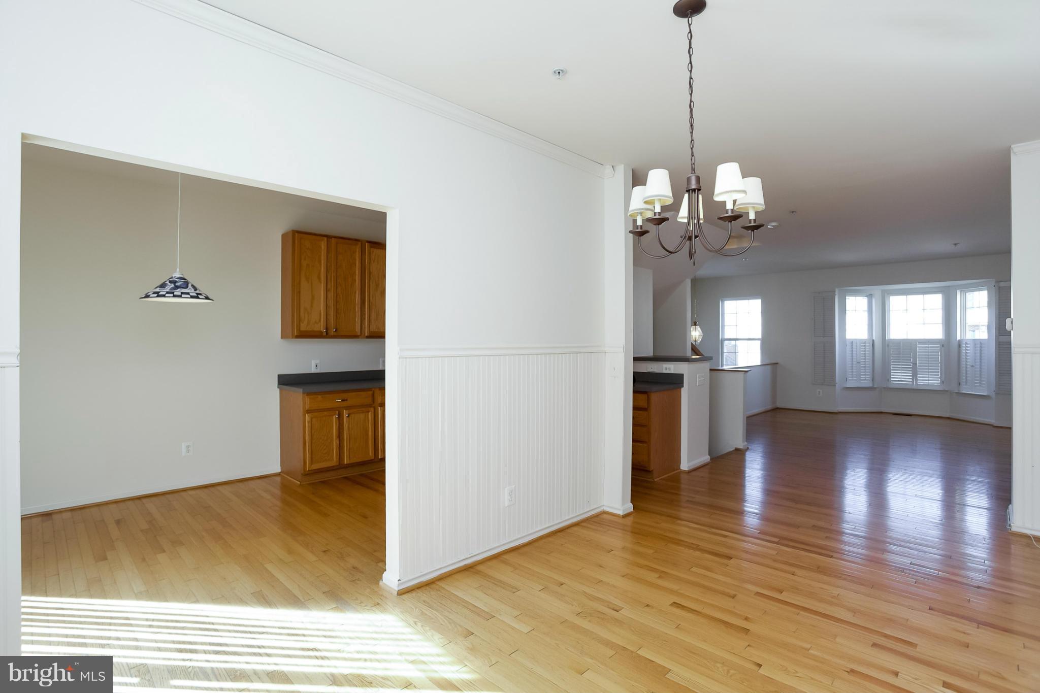 4130 Cutty Sark Road Baltimore, MD 21220 - Photo 11 of 24 a view of a livingroom with wooden floor and kitchen space