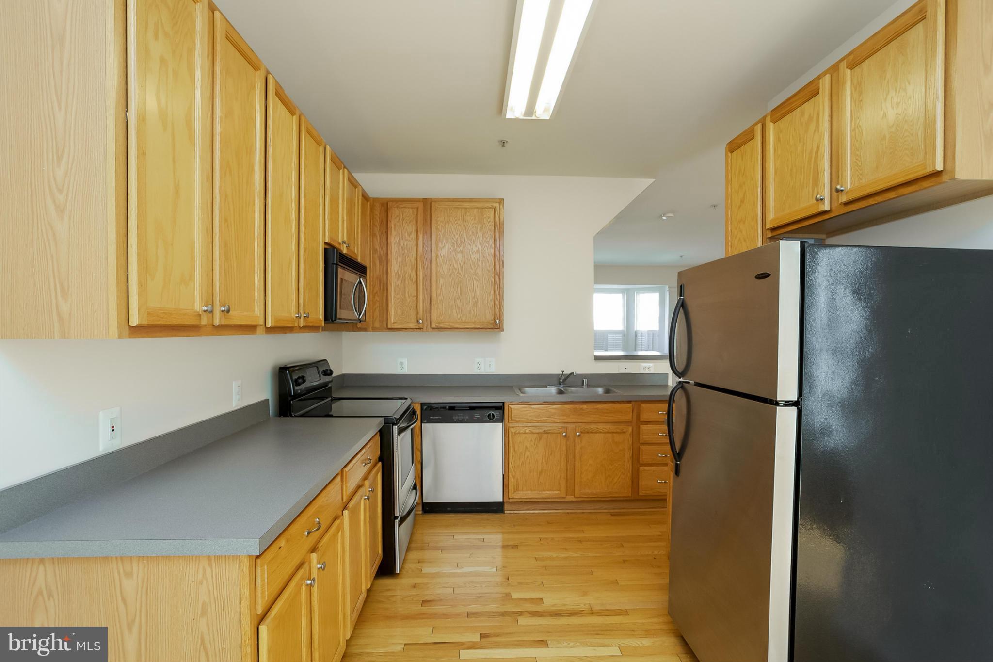 4130 Cutty Sark Road Baltimore, MD 21220 - Photo 13 of 24 a kitchen with a refrigerator a sink and a cabinets
