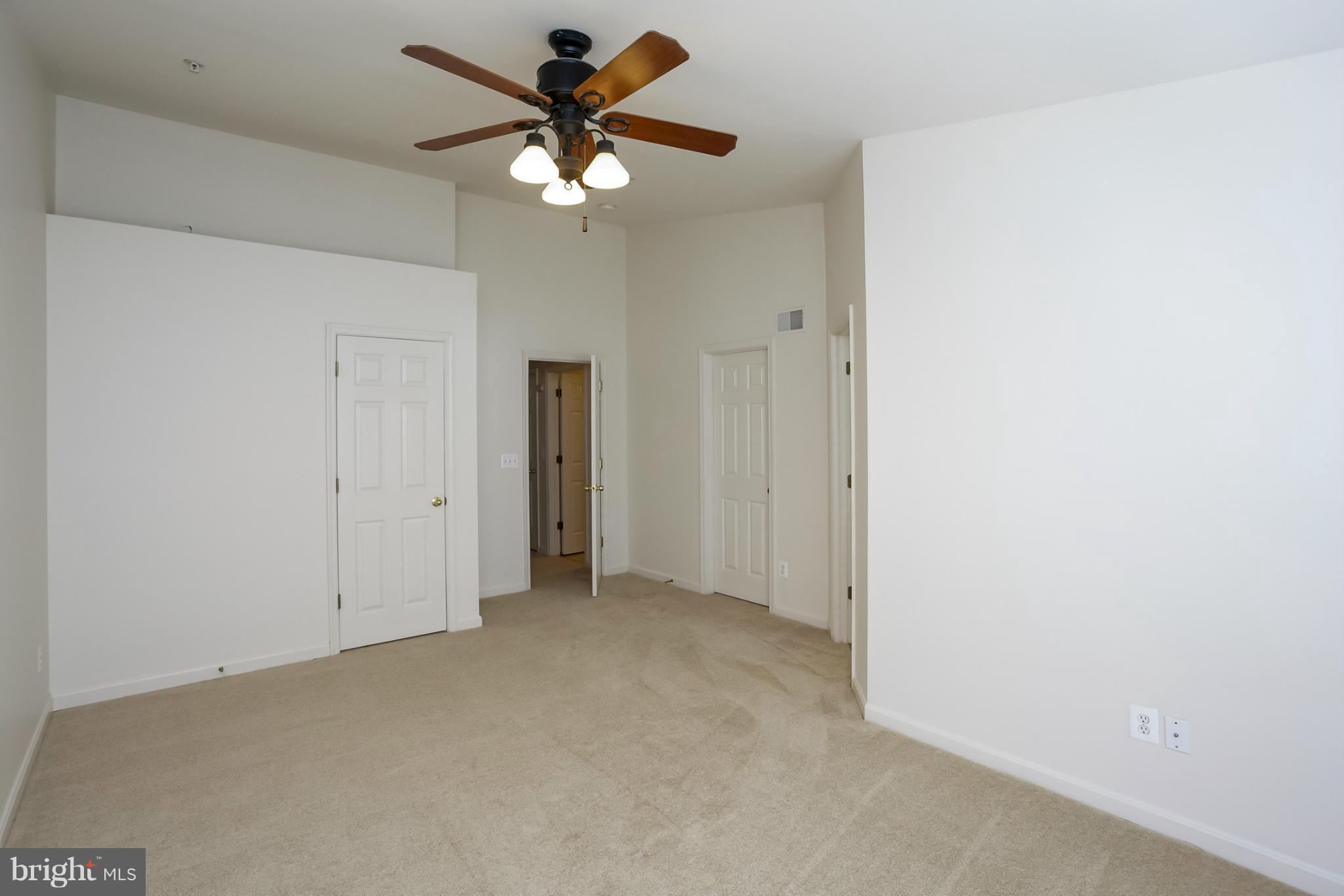 4130 Cutty Sark Road Baltimore, MD 21220 - Photo 21 of 24 an empty room with a ceiling fan and a window