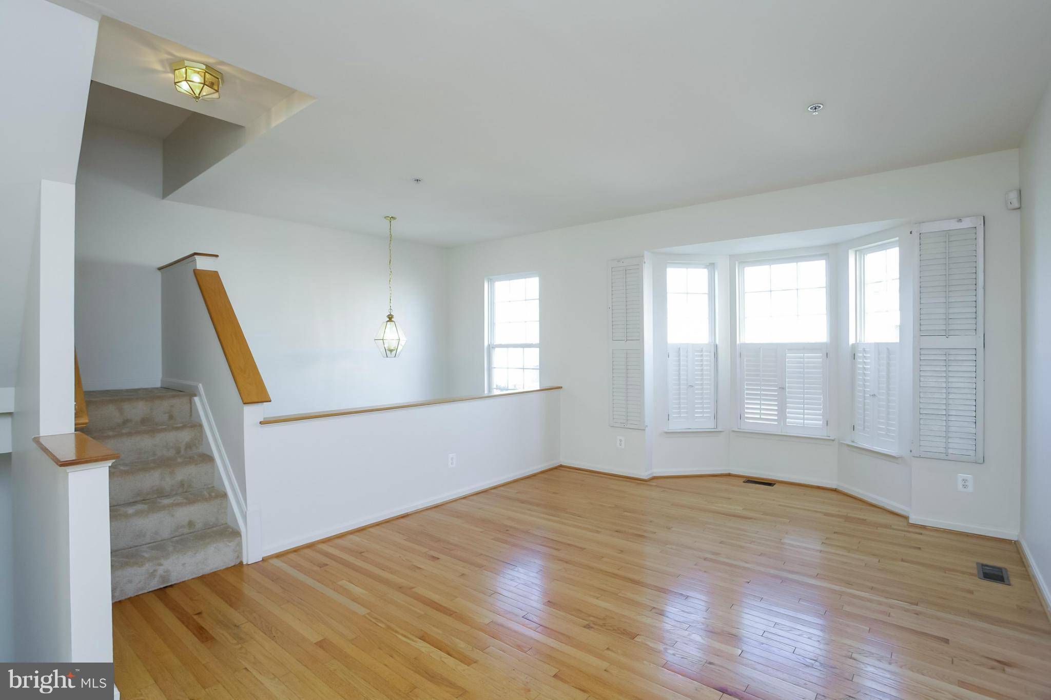 4130 Cutty Sark Road Baltimore, MD 21220 - Photo 8 of 24 a view of an empty room with wooden floor and a window