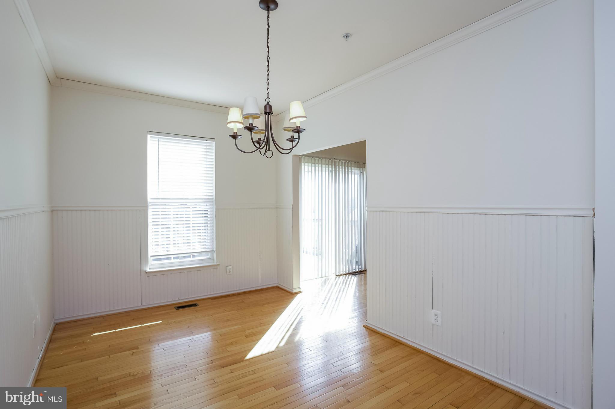 4130 Cutty Sark Road Baltimore, MD 21220 - Photo 10 of 24 a view of an empty room with wooden floor and a window