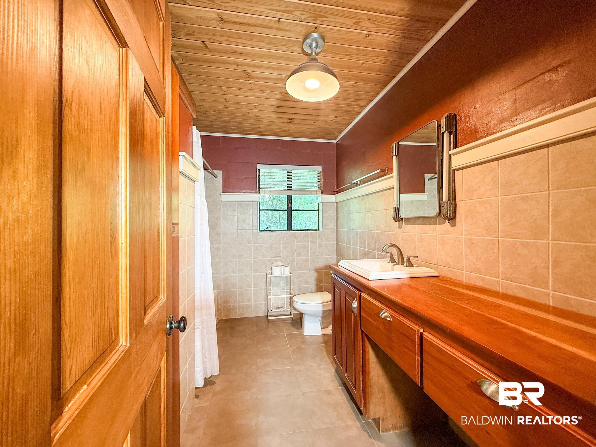 18711 Keller Road Foley, AL 36535 - Photo 19 of 38 Bathroom featuring a wood-panel ceiling, tiled walls, and a wood-finish vanity with an integrated sink