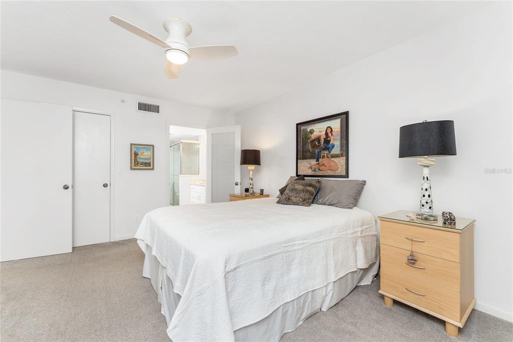 1591 Beach Road, Unit 307 Englewood, FL 34223 - Photo 23 of 45 a bedroom with a bed and a flat screen tv