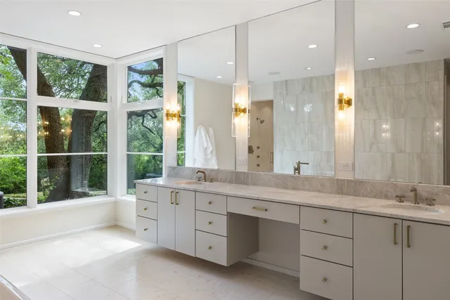 a bathroom with a double vanity sink and a large mirror