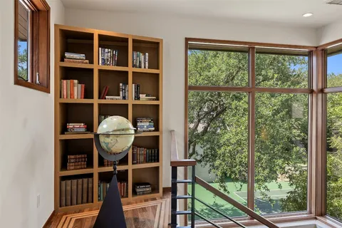 a view of a workspace with furniture and a window