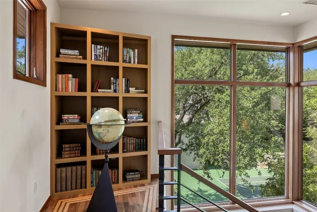 a view of a workspace with furniture and a window