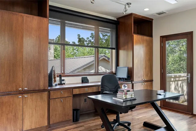 a view of yard from deck with patio