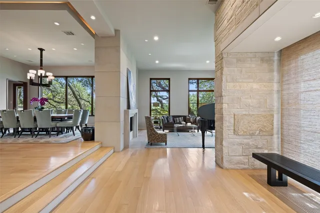 a living room with a fireplace and a floor to ceiling window