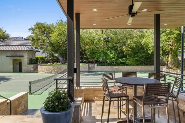 a view of a patio with a table and chairs and potted plants