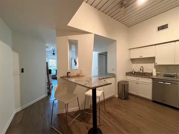a kitchen with stainless steel appliances granite countertop a stove and a refrigerator
