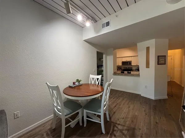 a dining room with furniture and wooden floor