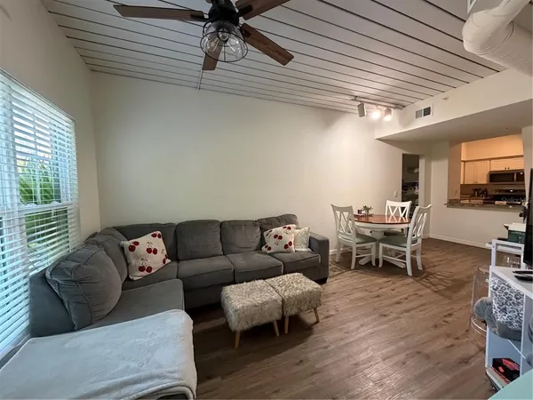 a living room with furniture and wooden floor