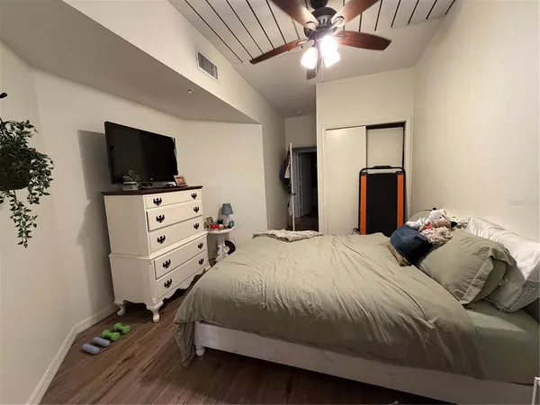 a bedroom with a bed and a flat screen tv