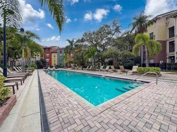 a swimming pool with outdoor seating and yard